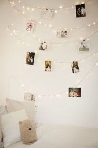 Hang your favorite photos using Christmas lights