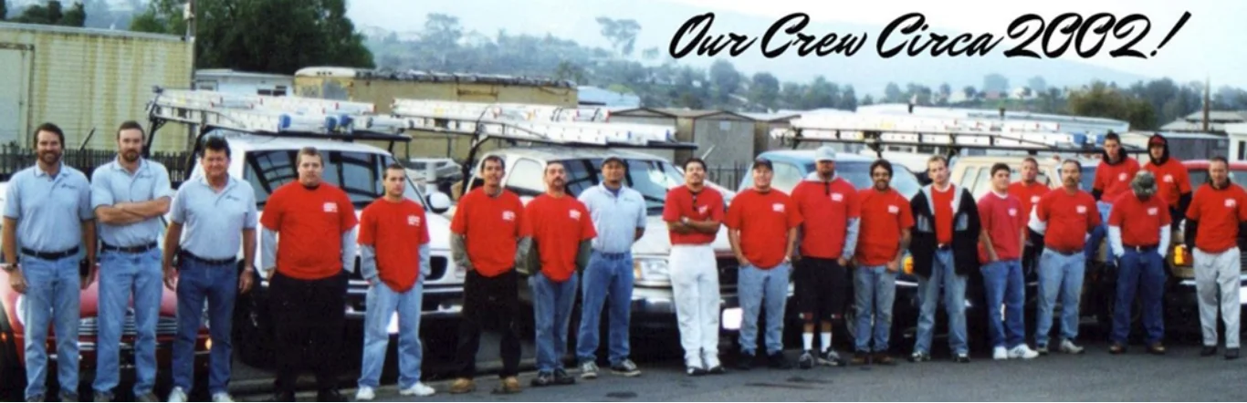 We Hang Christmas Lights installation crew in front of their trucks, circa 2002