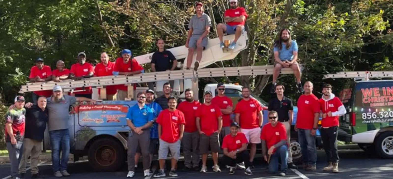 We Hang Christmas Lights installer team with bucket truck and service vehicles