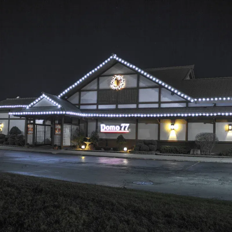 Restaurant building outlined in white Christmas lights at night